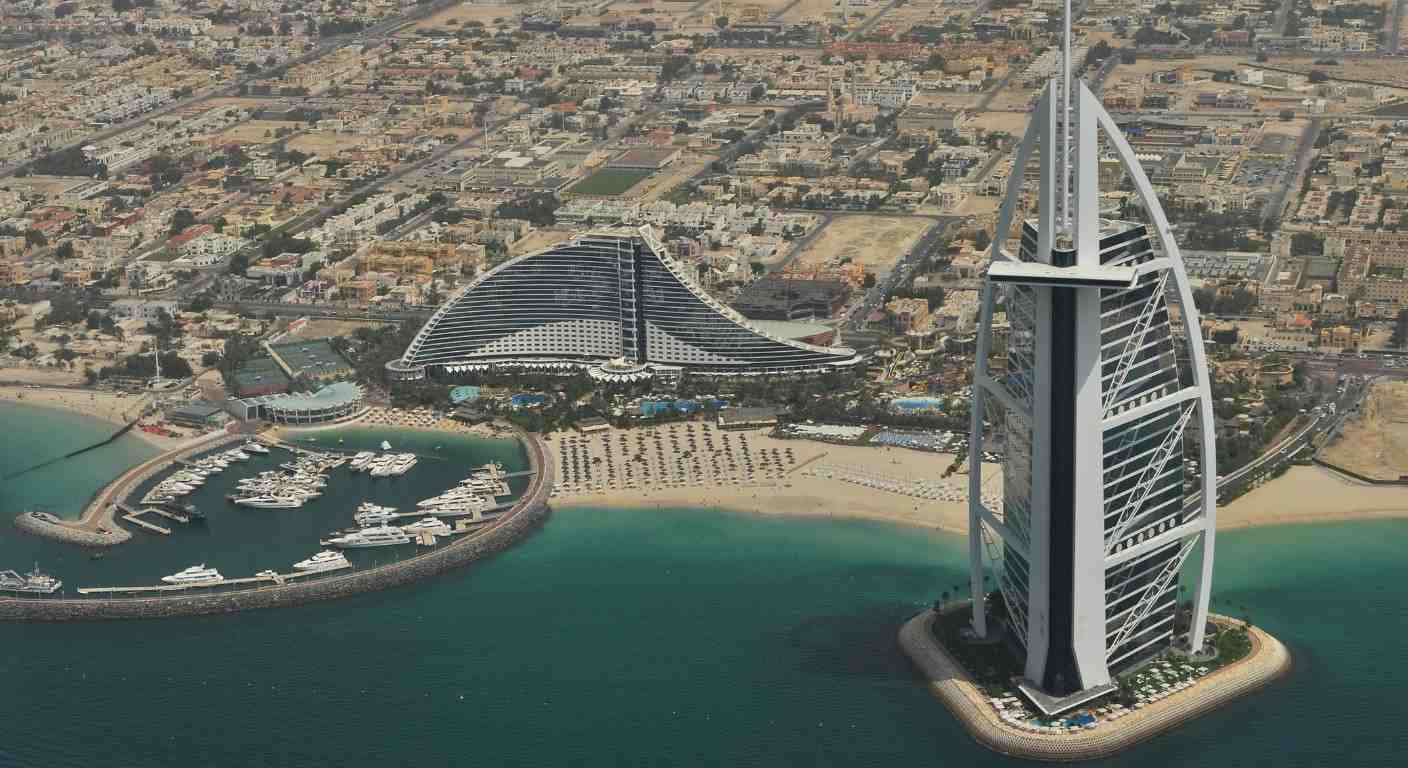 Aerial view of Burj Al Arab Jumeirah with private beach, marina and turquoise Arabian Gulf