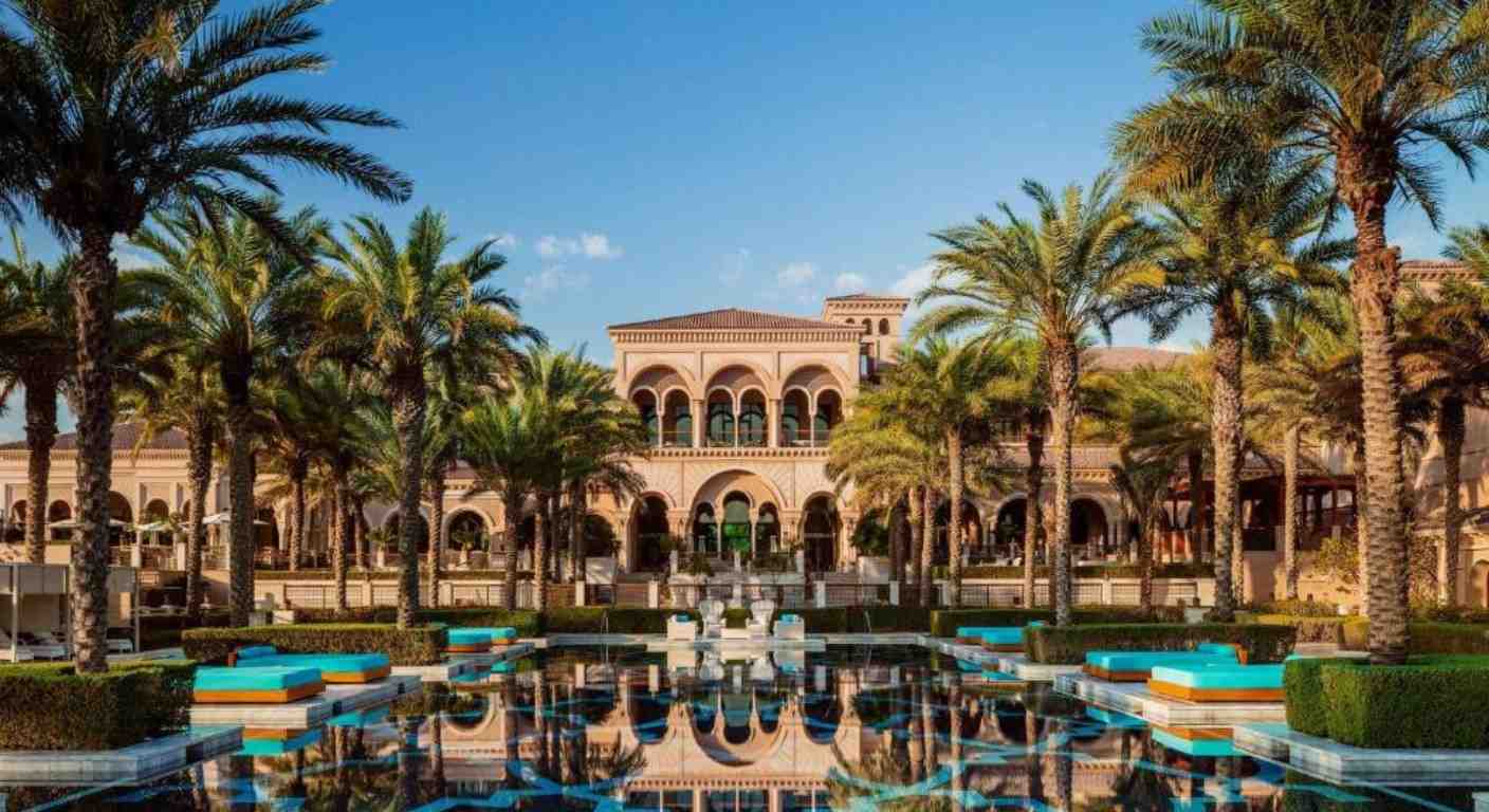 Luxury courtyard and palm-lined pool at One&Only The Palm Dubai with private beach access