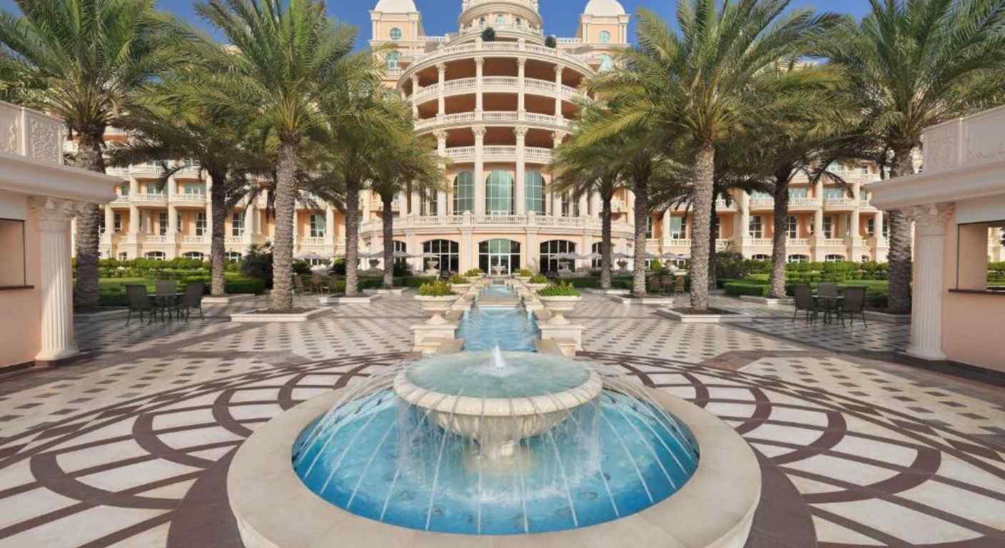 Grand entrance and landscaped gardens at Raffles The Palm Dubai luxury beachfront resort