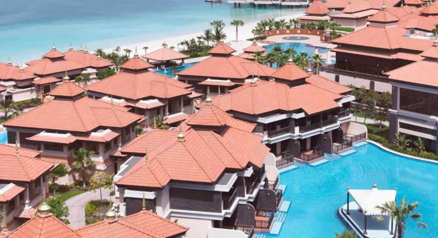 Overwater villas and lagoon pools at Anantara The Palm Dubai Resort with private beach