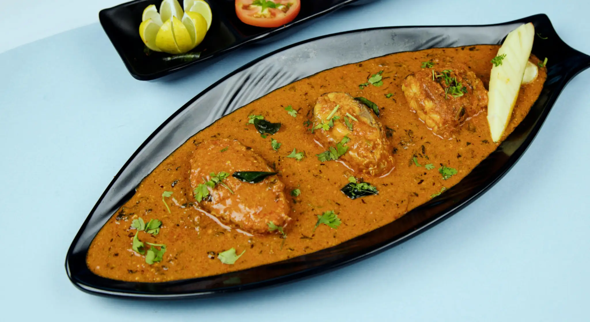 Indian fish curry served with garnish