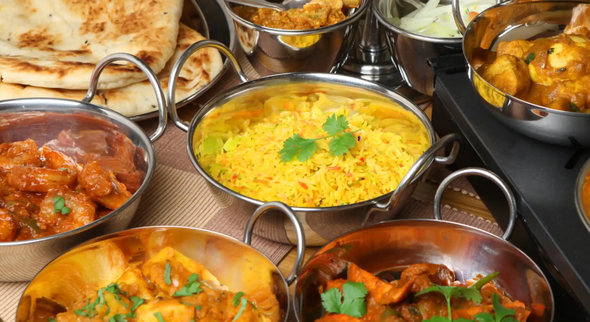 Indian buffet spread with curries and rice dishes