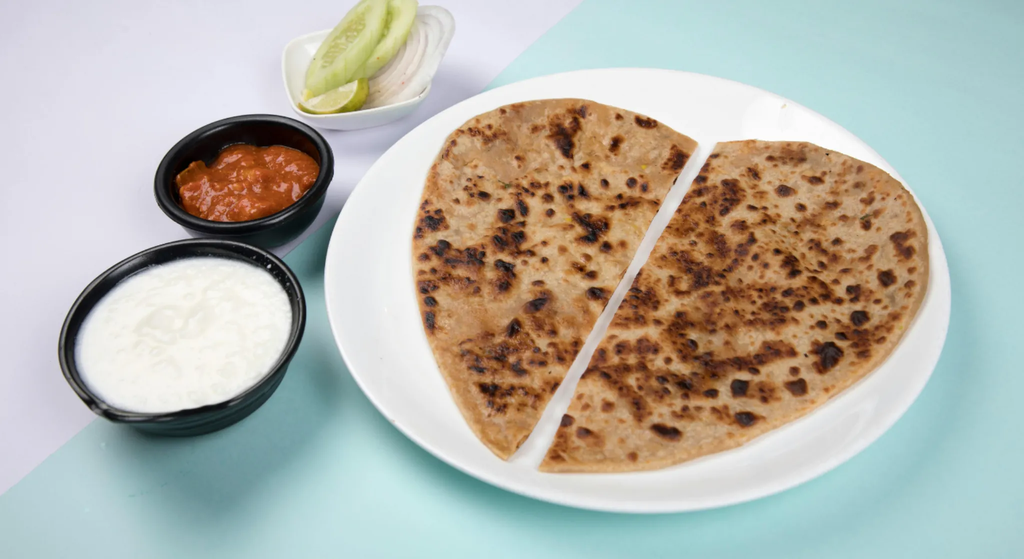Stuffed paratha with yoghurt and chutney