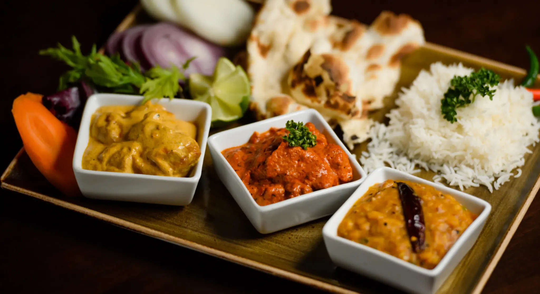 Indian thali platter with curry, rice and naan bread
