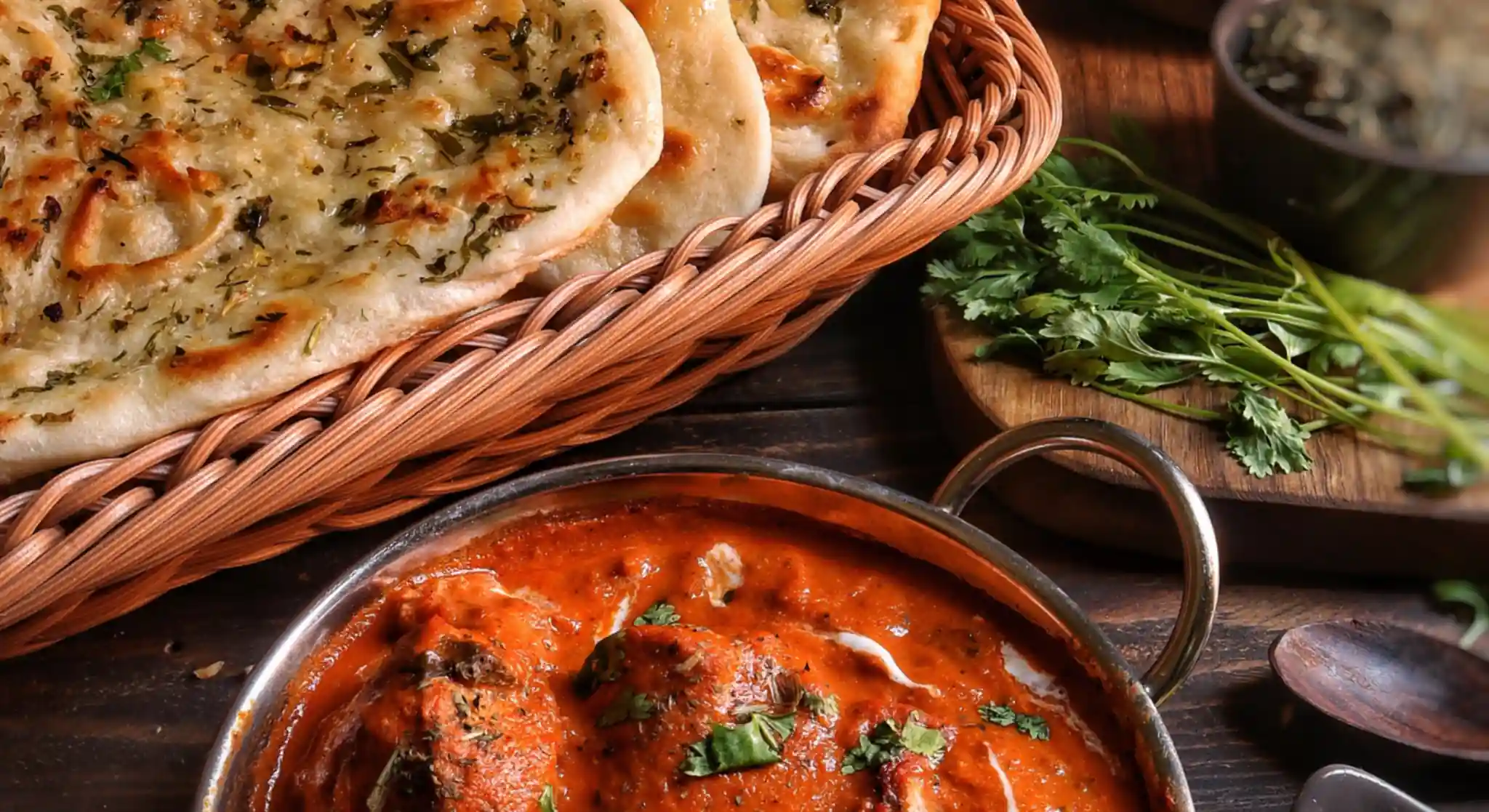 Butter chicken curry with naan bread basket