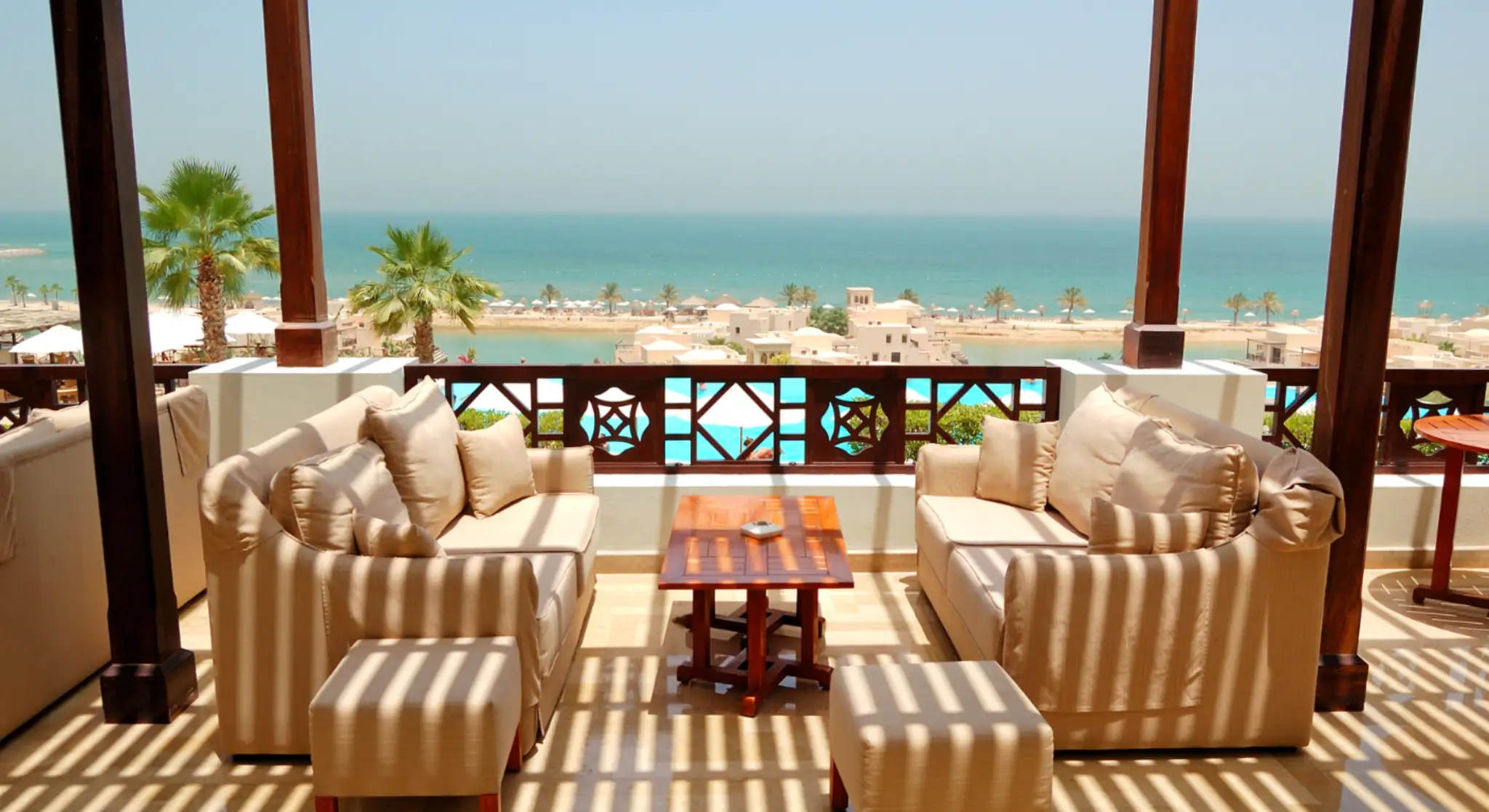 Luxury beachfront terrace with seating overlooking the Arabian Sea, ideal for a relaxing weekend getaway in Ras Al Khaimah