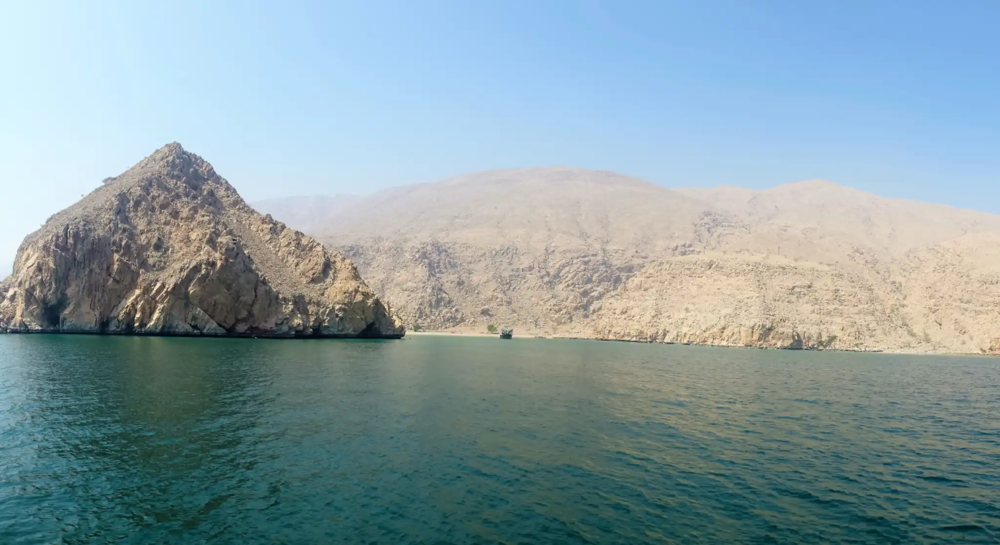 Scenic Musandam fjords with rocky mountains and calm turquoise waters near Oman coast