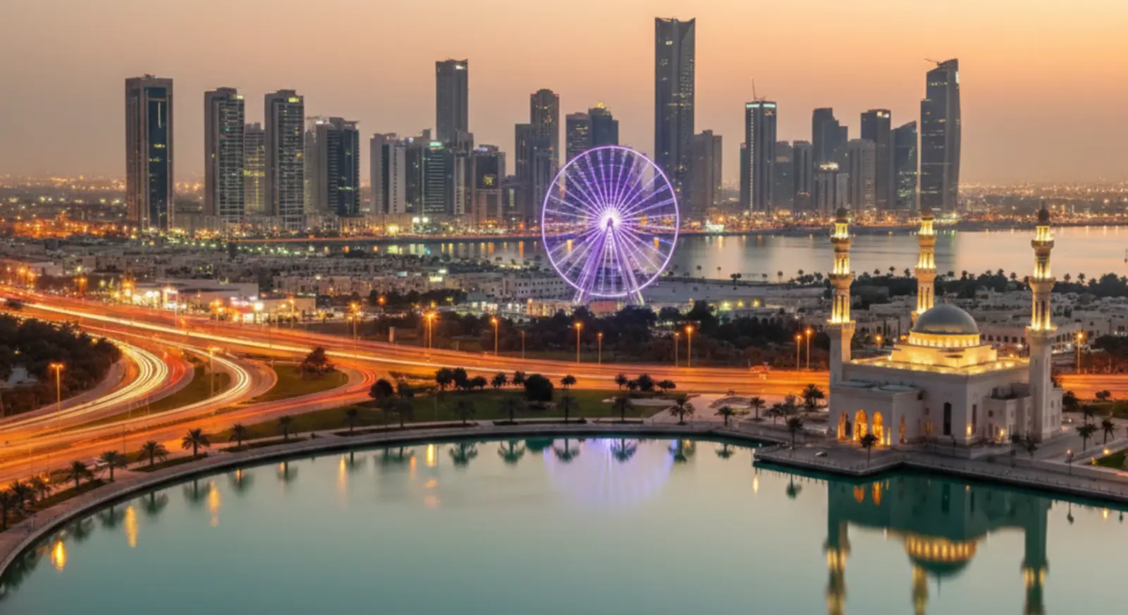 Sharjah skyline at sunset with Al Noor Mosque and Ferris wheel UAE