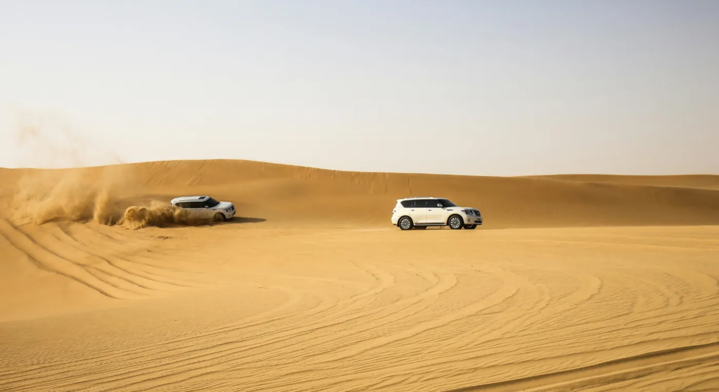4x4 dune bashing in Dubai desert with SUVs driving across sand dunes