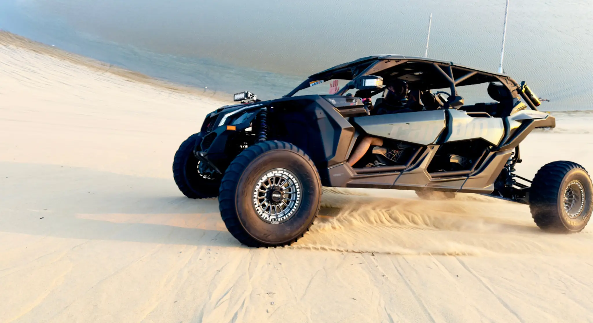 High-performance dune buggy driving across Dubai desert sand dunes 