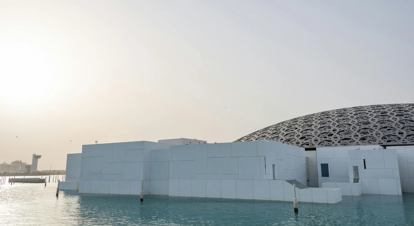 Louvre Abu Dhabi museum exterior with iconic dome over water.
