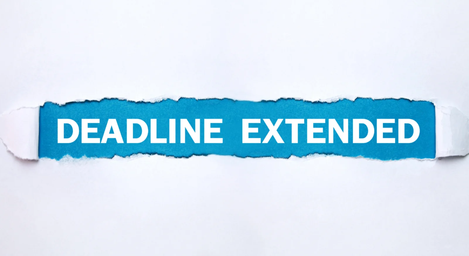 Deadline extended text on torn paper background.