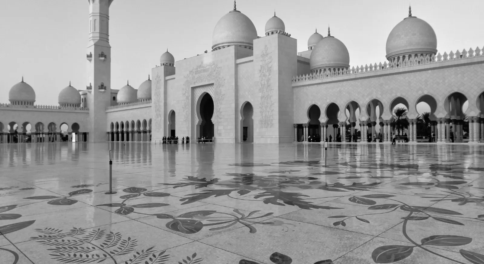Exterior view of Sheikh Zayed Grand Mosque with domes and courtyard.