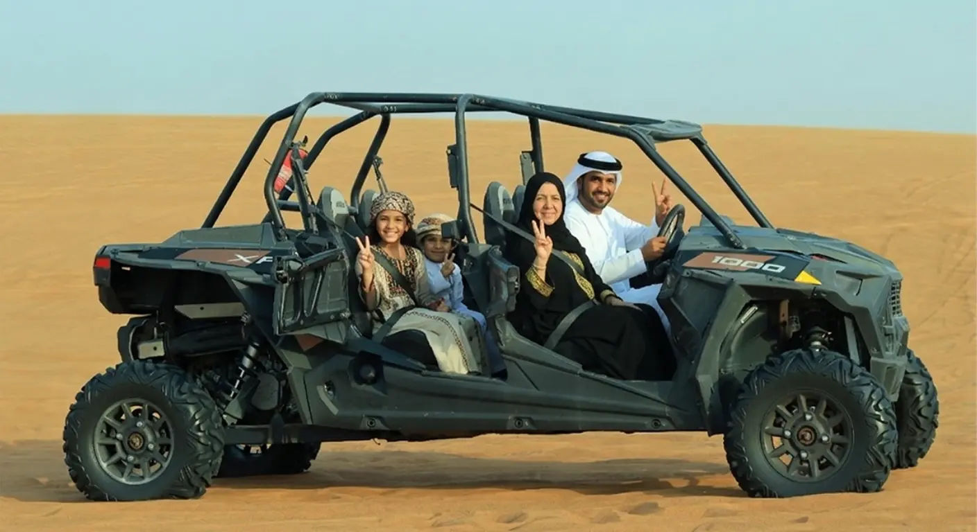 Family enjoying dune buggy ride in Dubai desert safari with off-road adventure experience