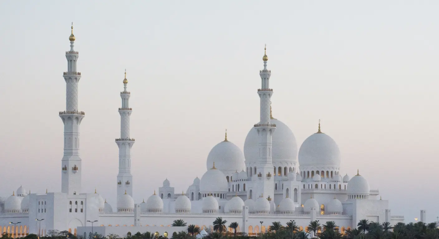 Sheikh Zayed Grand Mosque Abu Dhabi exterior view with white domes and minarets at sunset