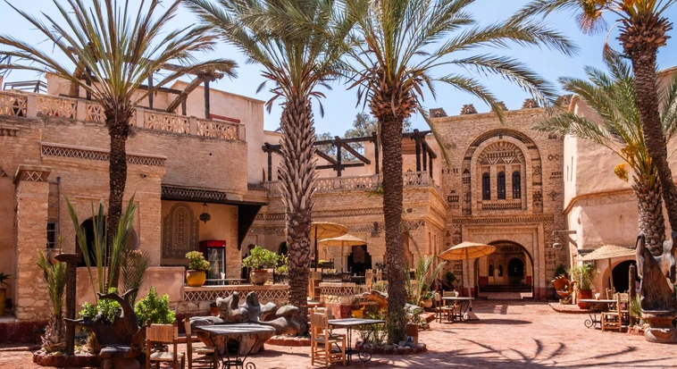 Courtyard tables under a tree at Arabian Tea House, a heritage Emirati cafe in Al Fahidi, Dubai