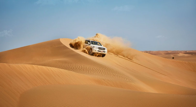 4x4 dune bashing across the Abu Dhabi desert during an evening safari