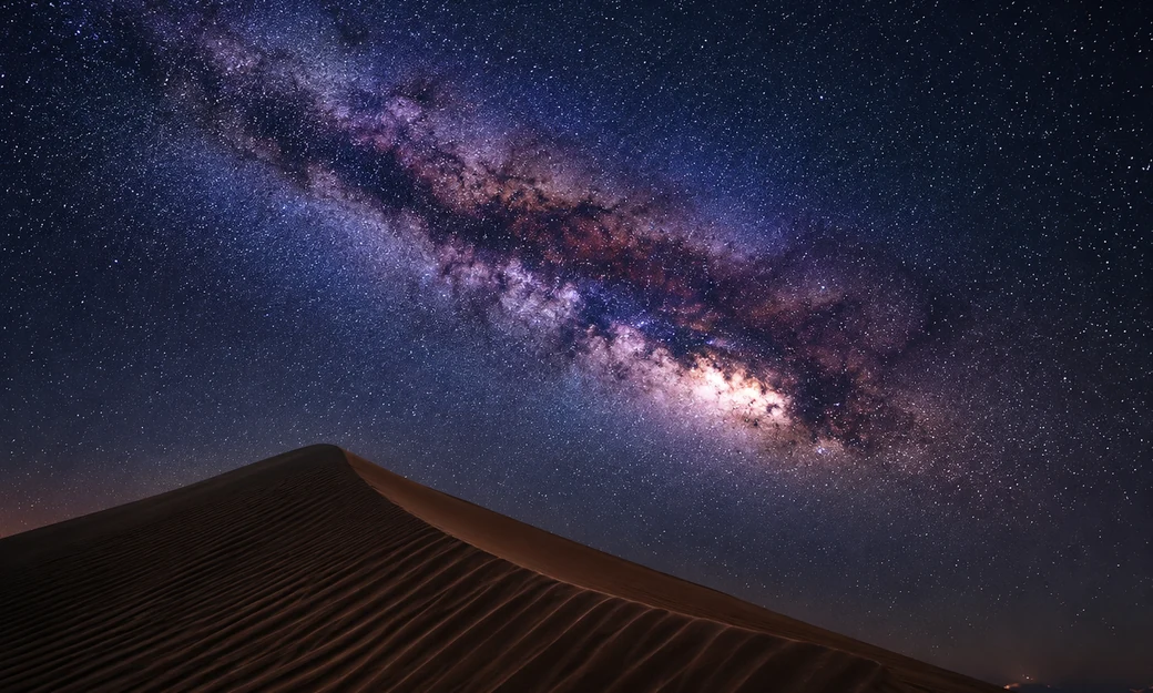 Bright Milky Way galactic core above a sand dune at Al Quaa desert