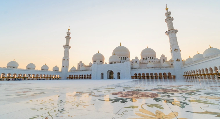 Sheikh Zayed Grand Mosque courtyard and domes in Abu Dhabi during sunset