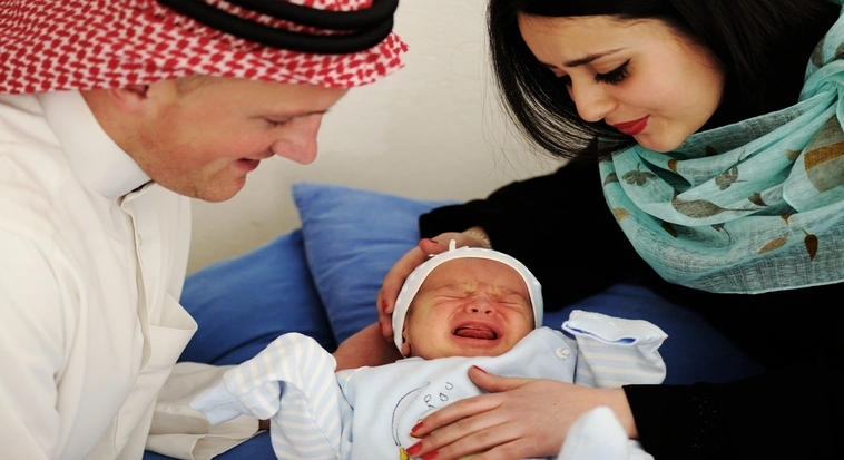 Mother holding her newborn baby after childbirth in a Dubai hospital