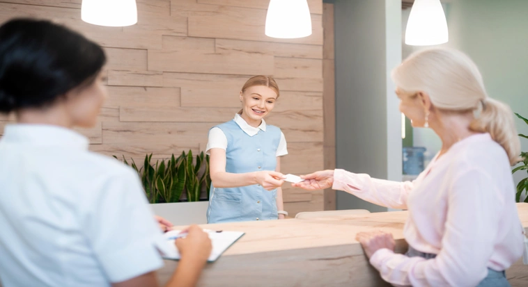 Visitor receiving assistance at a medical clinic reception during a stay in Dubai