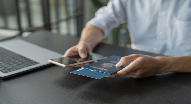 Traveller holding a passport and boarding pass while planning a multi-country Gulf trip