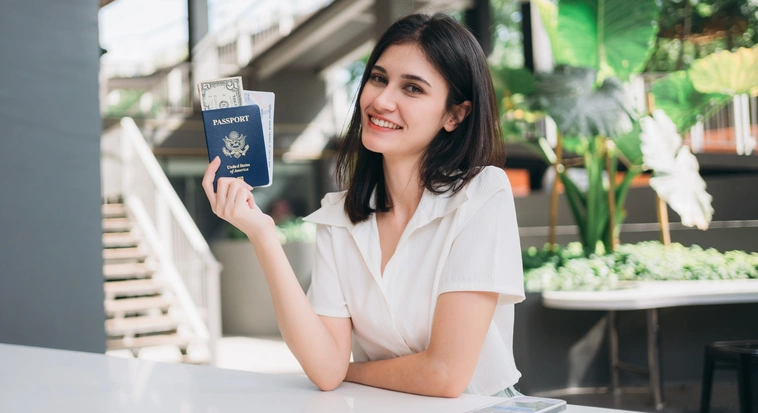 Traveller holding a passport and travel documents while preparing a Dubai tourist visa application