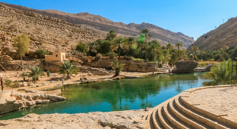 Mountain oasis and palm trees in Oman during a trip from Dubai