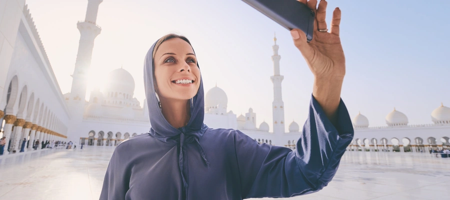 Woman wearing a headscarf and loose clothing at Sheikh Zayed Grand Mosque in Abu Dhabi
