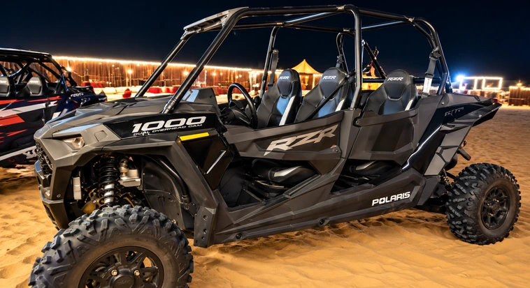 Polaris buggy climbing an Al Khatim dune during a private evening desert tour