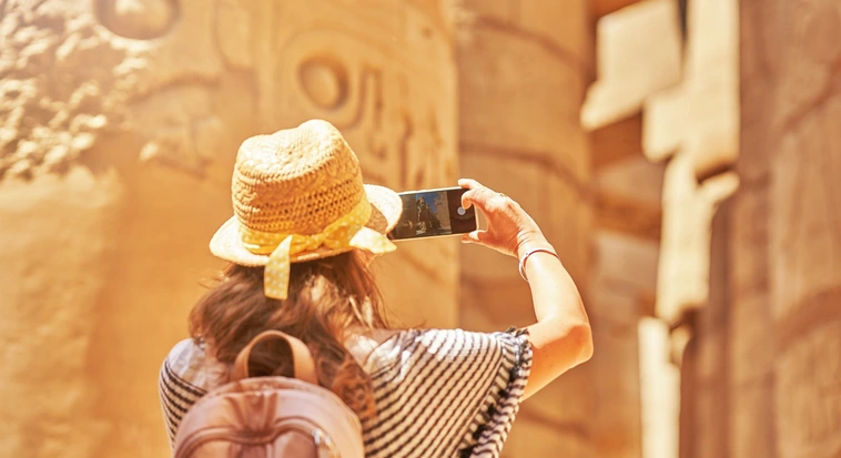 Tourist taking a photo inside Karnak Temple in Luxor during an Egypt trip