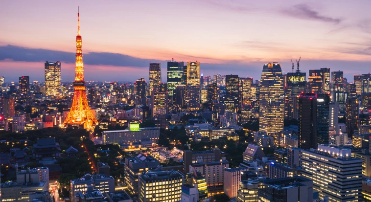 Tokyo Tower and illuminated city skyline at night in Japan
