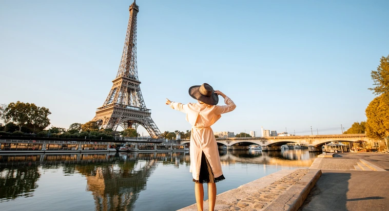 Traveller enjoying a view of the Eiffel Tower beside the Seine in Paris
