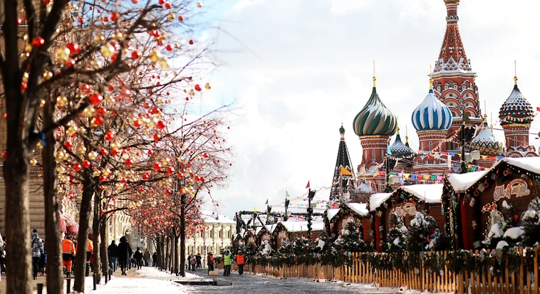Snow-covered street and Saint Basil’s Cathedral in Moscow, Russia