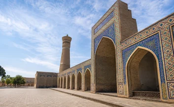 Poi Kalon complex with blue tiled arches and Kalon minaret in Bukhara, Uzbekistan