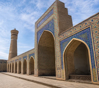 Poi Kalon complex with blue tiled arches and Kalon minaret in Bukhara, Uzbekistan