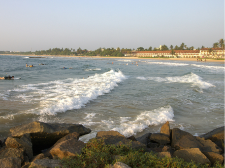 Waves rolling onto Bentota Beach with coastal resorts in the background, photographed by Jude Abraham during a south-coast route inspection for Arabiers