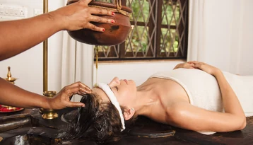 Traditional Ayurvedic oil treatment at a wellness retreat in Sri Lanka