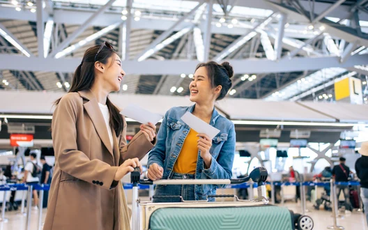 Travellers with flight tickets and luggage at an airport for international departures from Sri Lanka